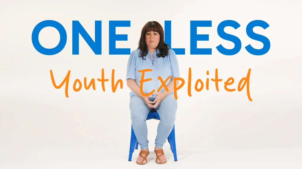A woman with brown hair sits on a blue chair against a white background. Large text behind her reads ONE LESS Youth Exploited in blue and orange letters.