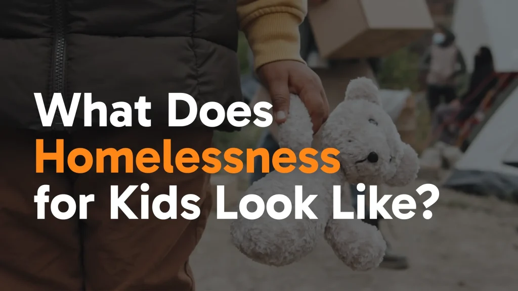 A child in a brown jacket holds a white teddy bear, with blurred people and tents in the background. Overlaid text reads: What Does Homelessness for Kids Look Like?.